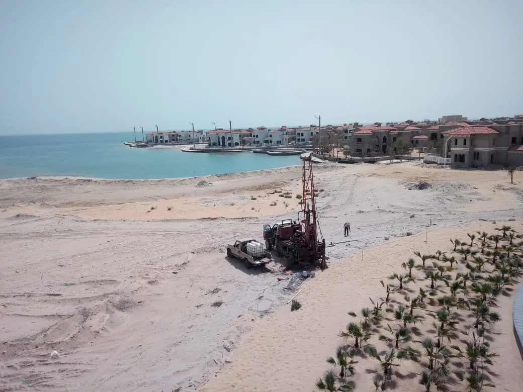 Drilling equipment on a sandy shoreline
