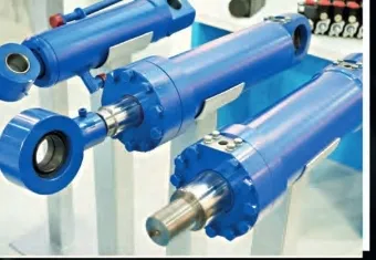 Blue hydraulic cylinders displayed in a workshop