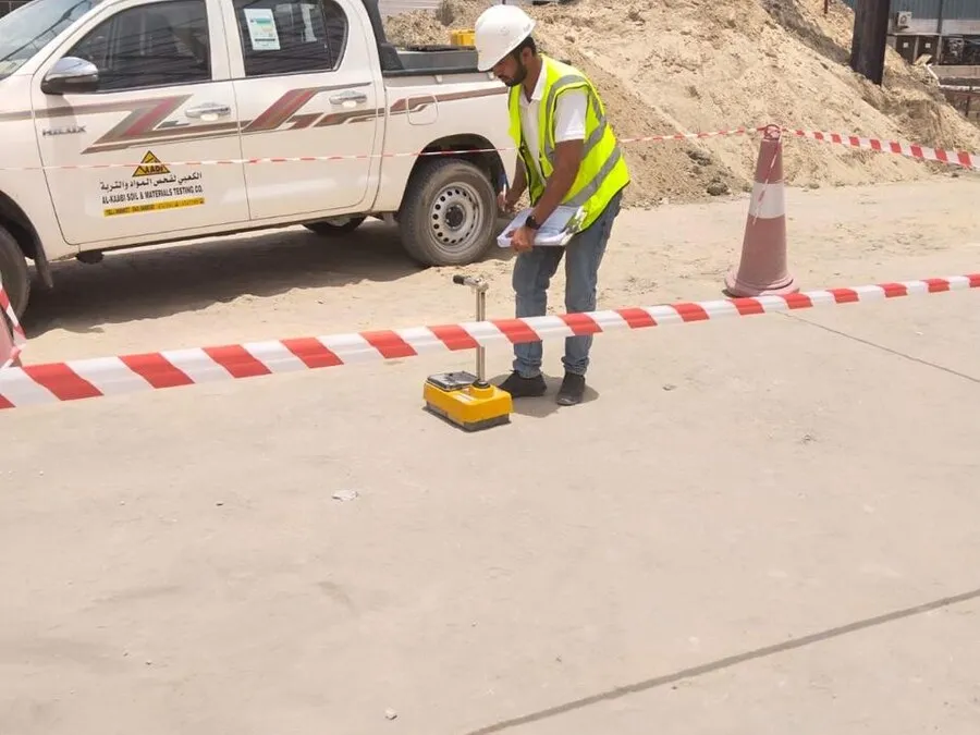 Field crew testing ground beside a marked area