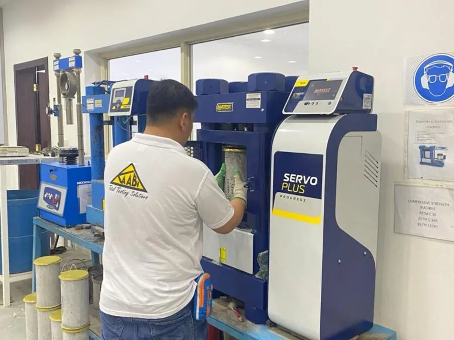Technician operating a laboratory testing machine